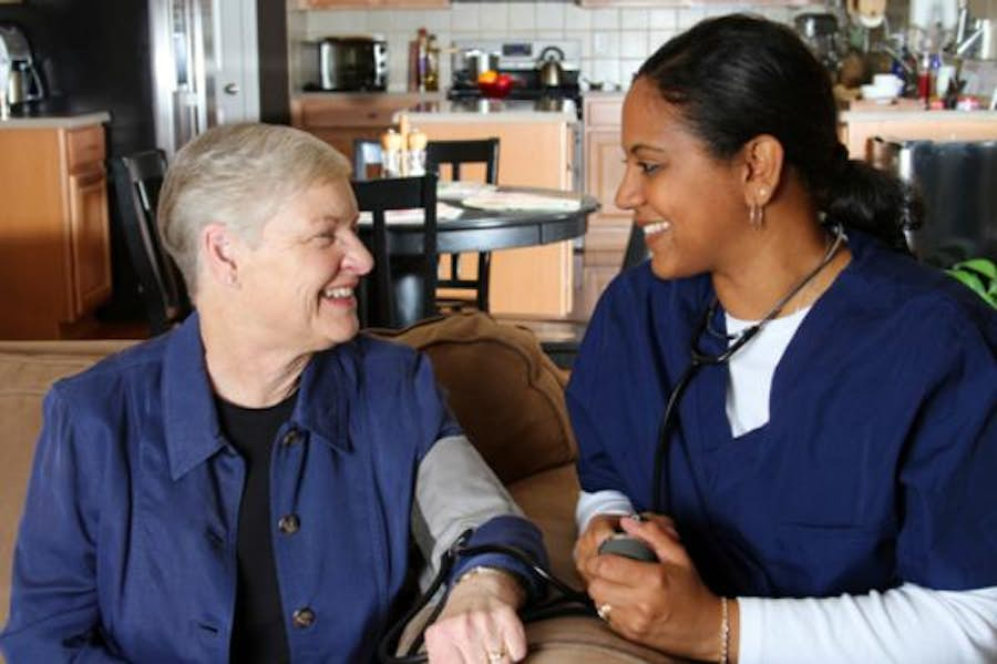 caregiver talking with client on sofa