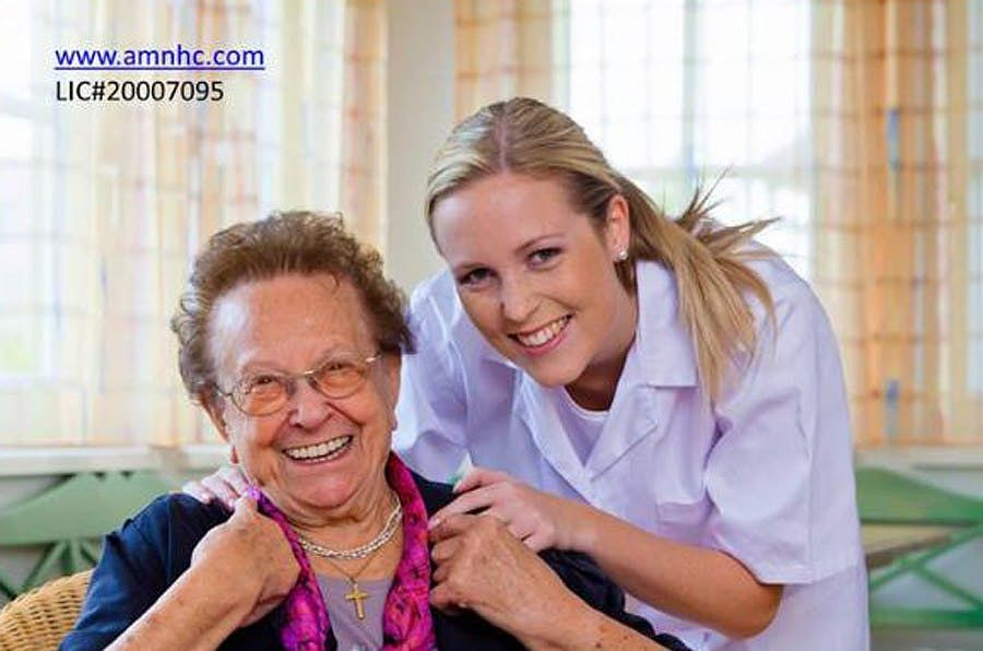 Woman sitting on sofa with caregiver 