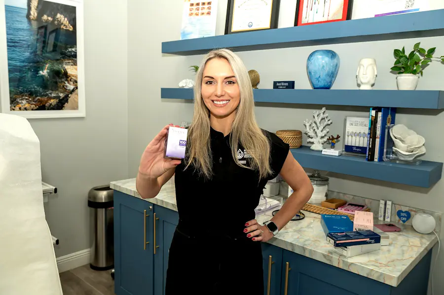 Refresh medical aesthetics provider holding a Botox product during an injectable consultation Refresh medical aesthetics provider holding a Botox product during an injectable consultation