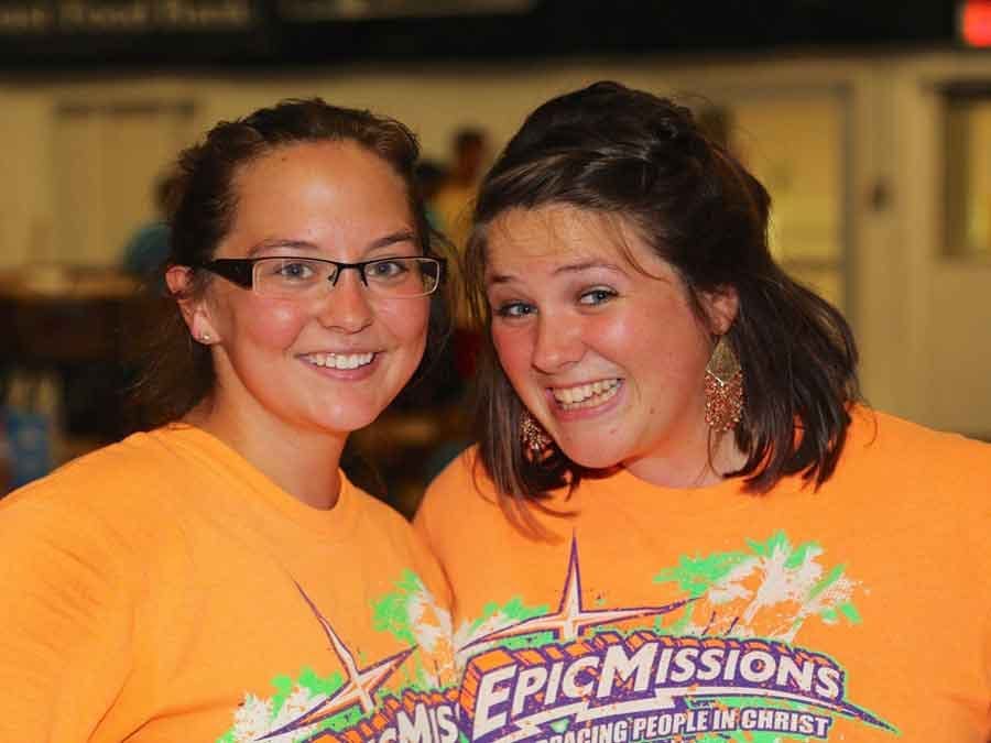 Two girls smiling with Epic Mission T-shirts on
