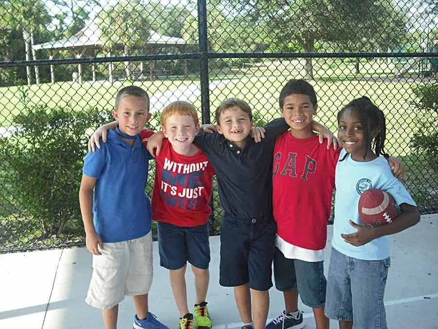 young Boys and Girls with arms around each lther