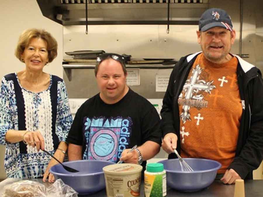 two men getting cooking lessons