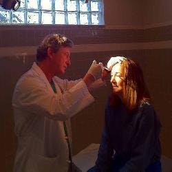 Dr. John McDonald doing an exam on a patient