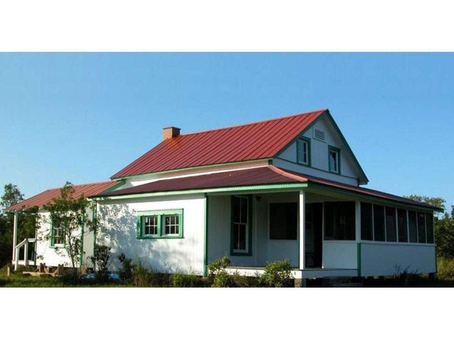 Historic home of poet Laura Riding Jackson with deep porches and large windows. 