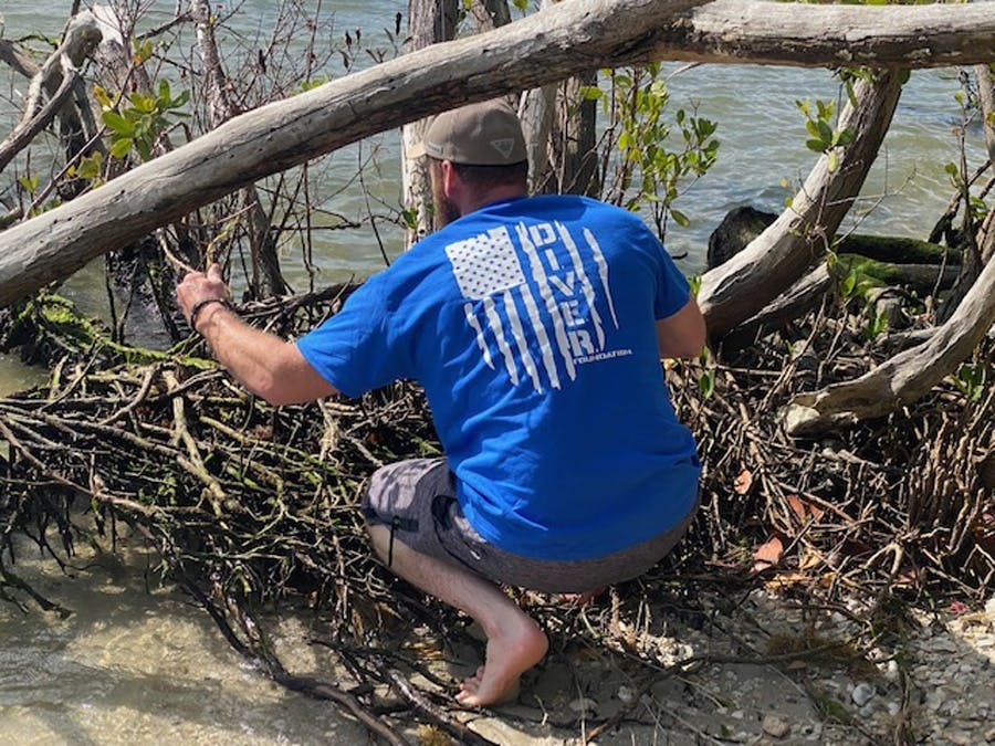 volunteer looking for waterway trash