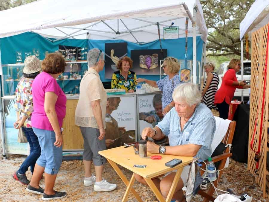 Ladies looking at jewelry display at art festival