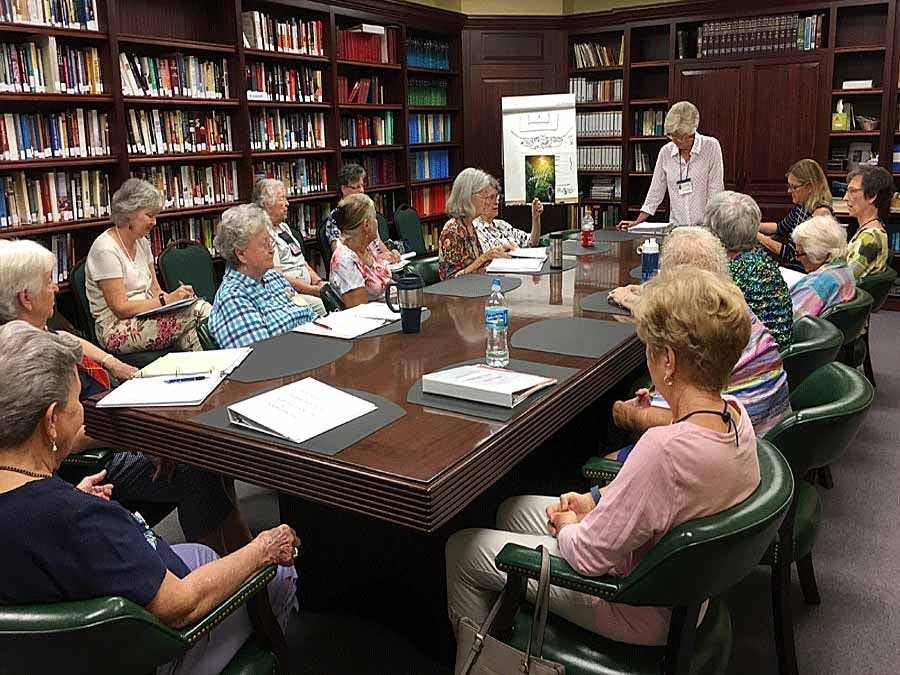 women meeting around a conference table at the Sunbonnet Sue Quilting Guild