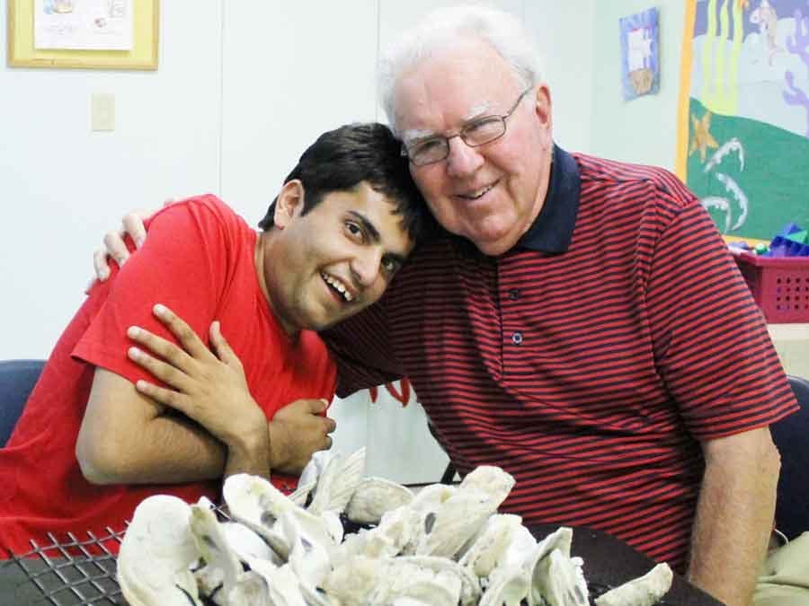 elderly man hugging boy