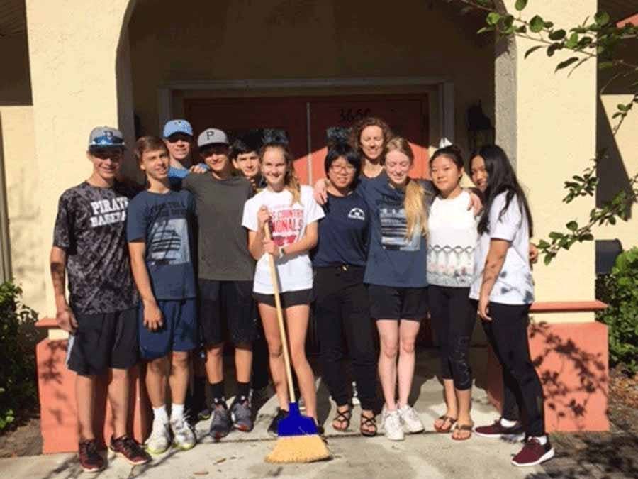 kids posing after cleaning up grounds