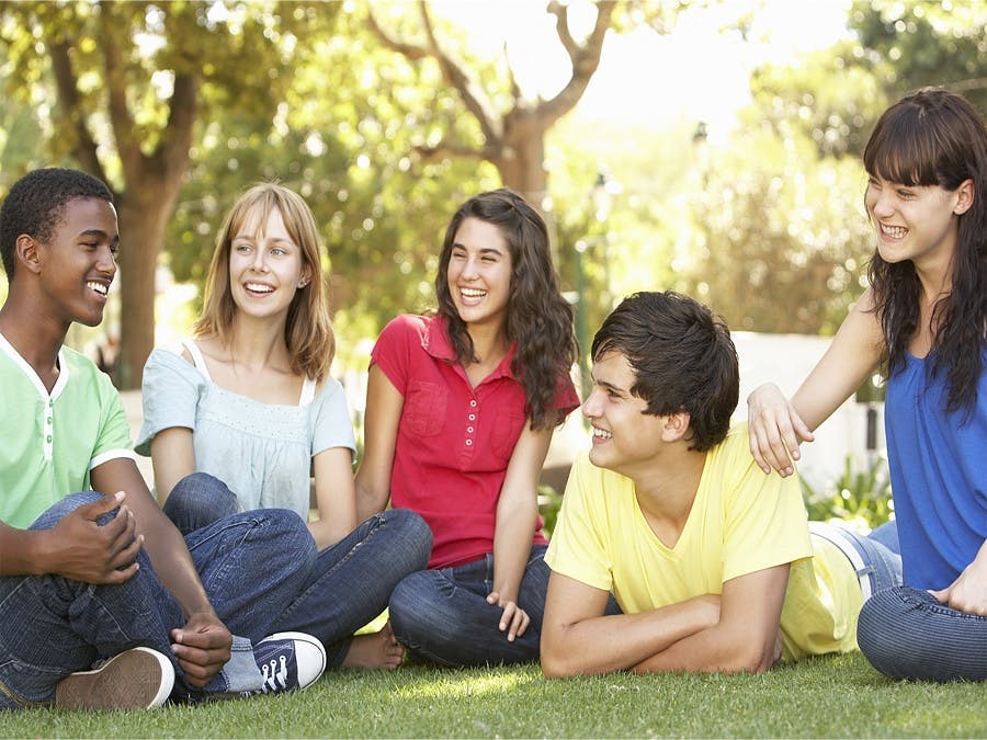 kids sitting on lawn talking