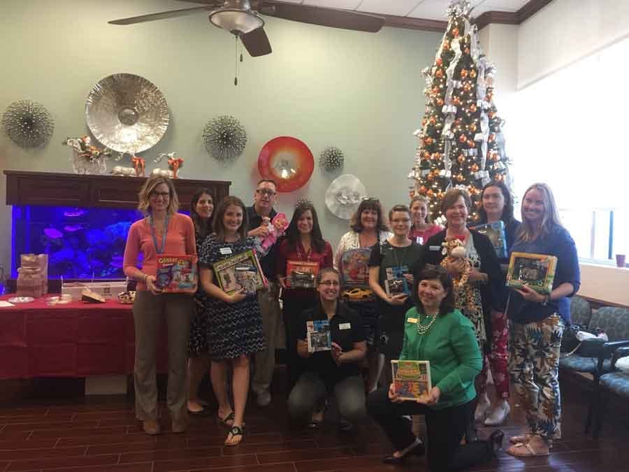 Florida Public Relations Association group photo in front of Christmas tree