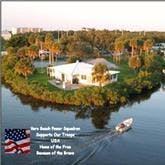 Boat passing by home on rivers edge
