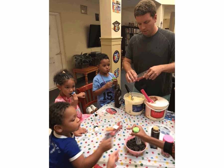Volunteer scooping out ice cream