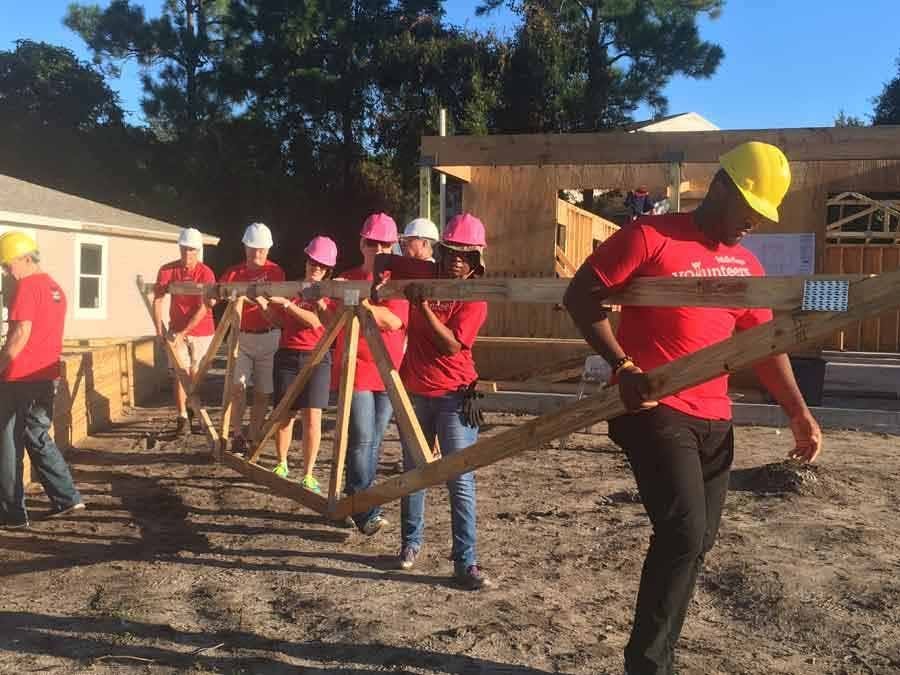 Volunteers carrying home truse