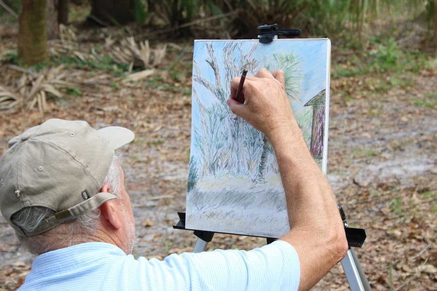 man sketching a tree